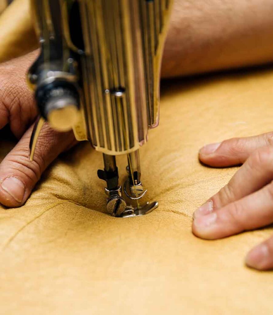 Détail d’une machine à coudre réalisant des finitions de sellerie française sur mesure de haute qualité