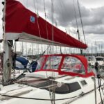 Taud, bome et capote rouge sur voilier à Cherbourg